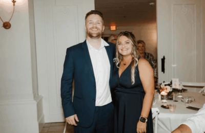 Dylan Henry, a North Texas health insurance agent, smiles alongside a woman at an indoor event.