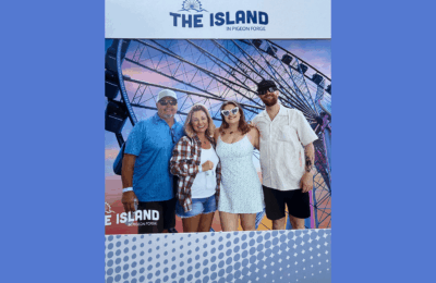 Dylan Henry, North Texas health insurance agent, smiles with his family in a photo booth at The Island in Pigeon Forge.